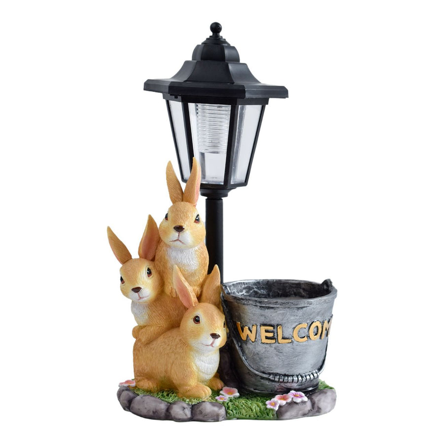 Solar Simulation Rabbit Ornament, charges by day and lights up automatically at night, three rabbits cluster around a street lamp with "WELCOME" bucket, warmly decorates courtyard and balcony, eco-friendly and healing./Resin flowerpot rabbit